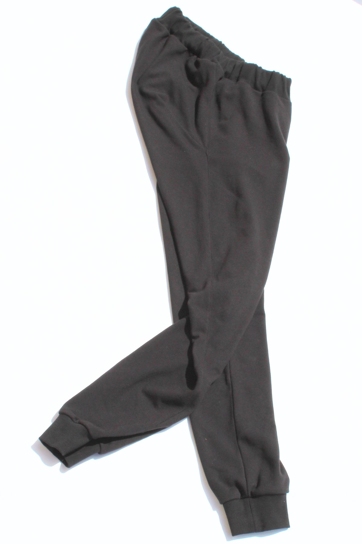 Vilber's adaptive joggers laid flat on white background, angled view showing the tapered leg and ribbed cuff detail.