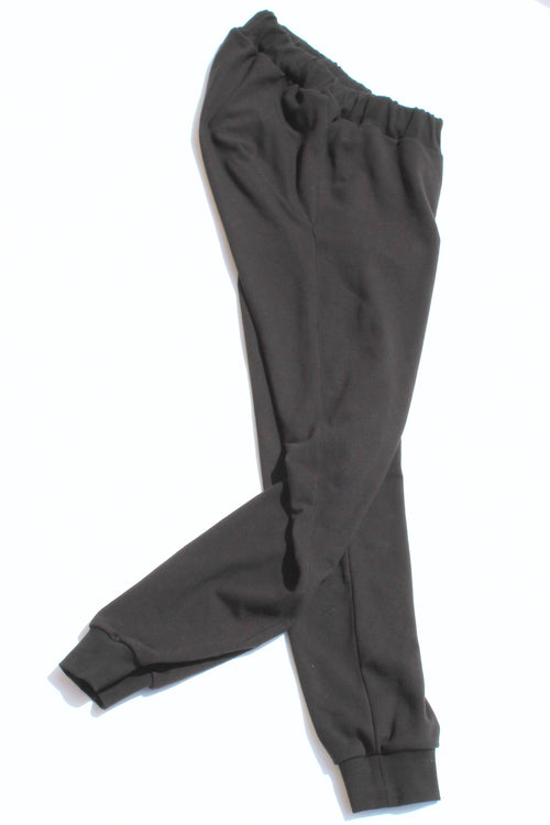 Vilber's adaptive joggers laid flat on white background, angled view showing the tapered leg and ribbed cuff detail.